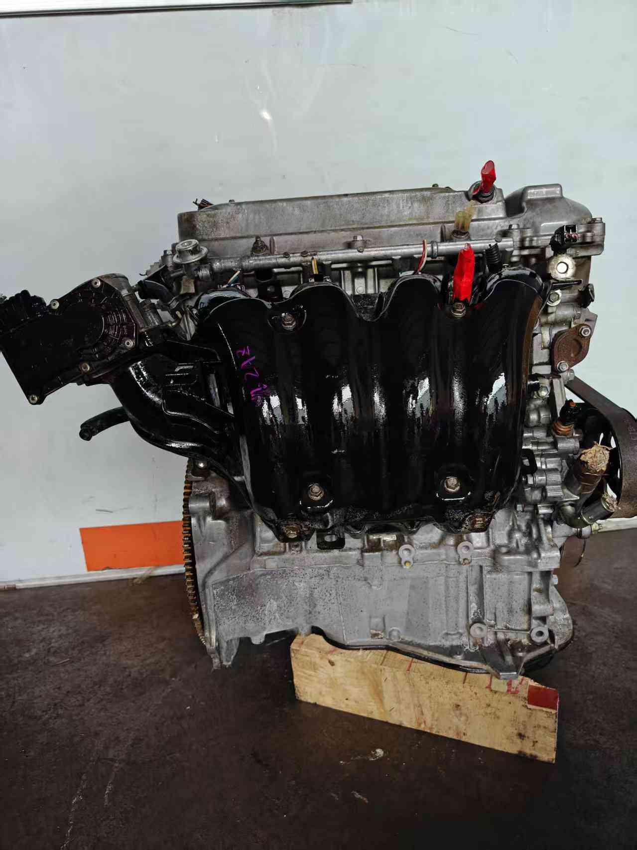Toyota 2AZ-FE engine side view with original components