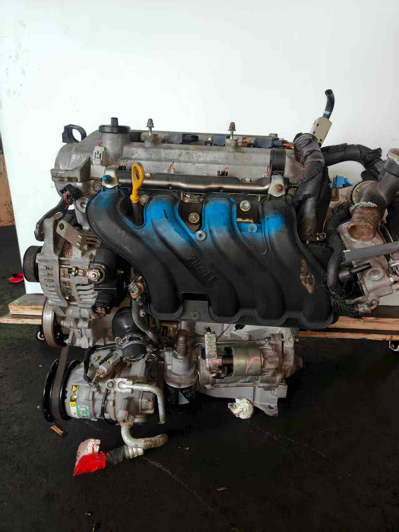 Toyota 2NZ-FE engine side view with original components