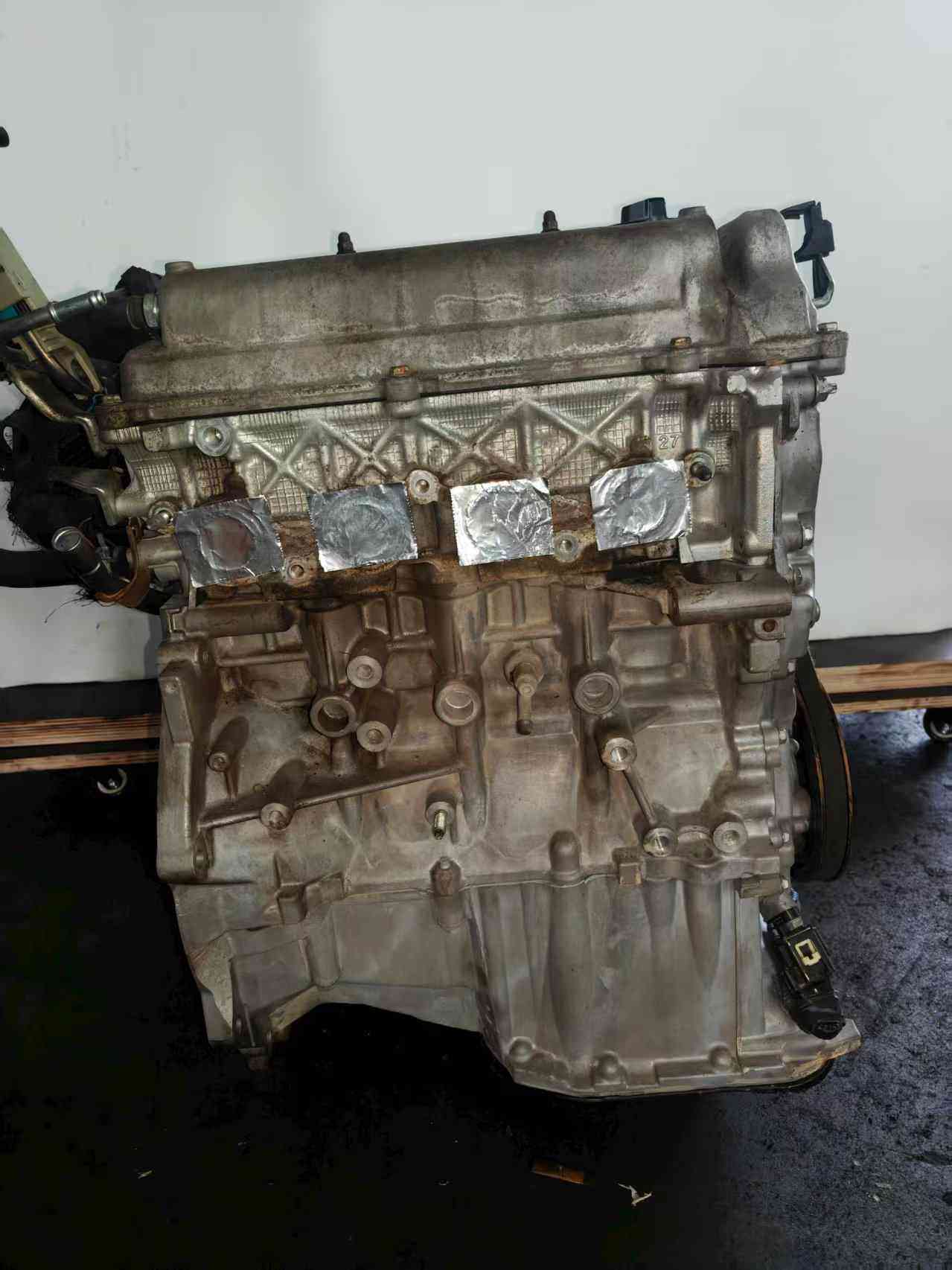 Real stock photo of used Toyota 2NZ-FE engine assembly
