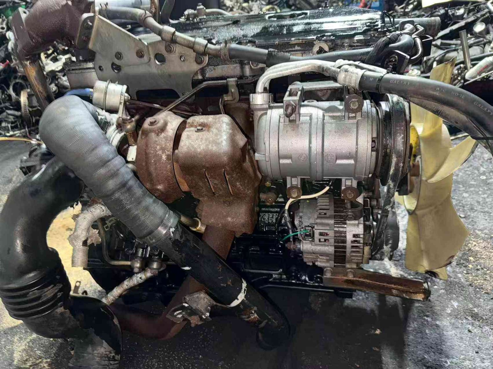 Complete Isuzu 4HK1 diesel engine assembly top view with EGR cooler and turbocharger