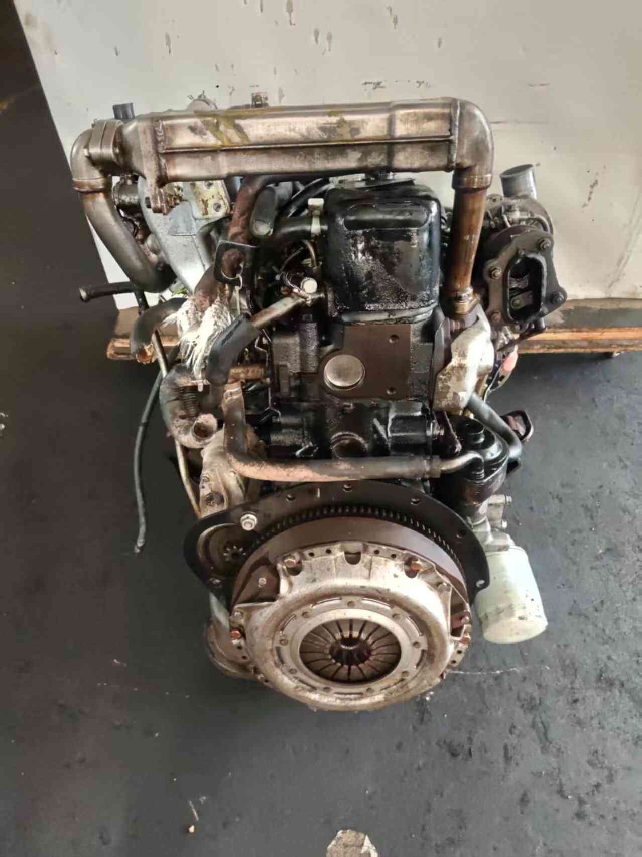 4JB1T turbo engine rear view with flywheel clutch assembly and turbocharger