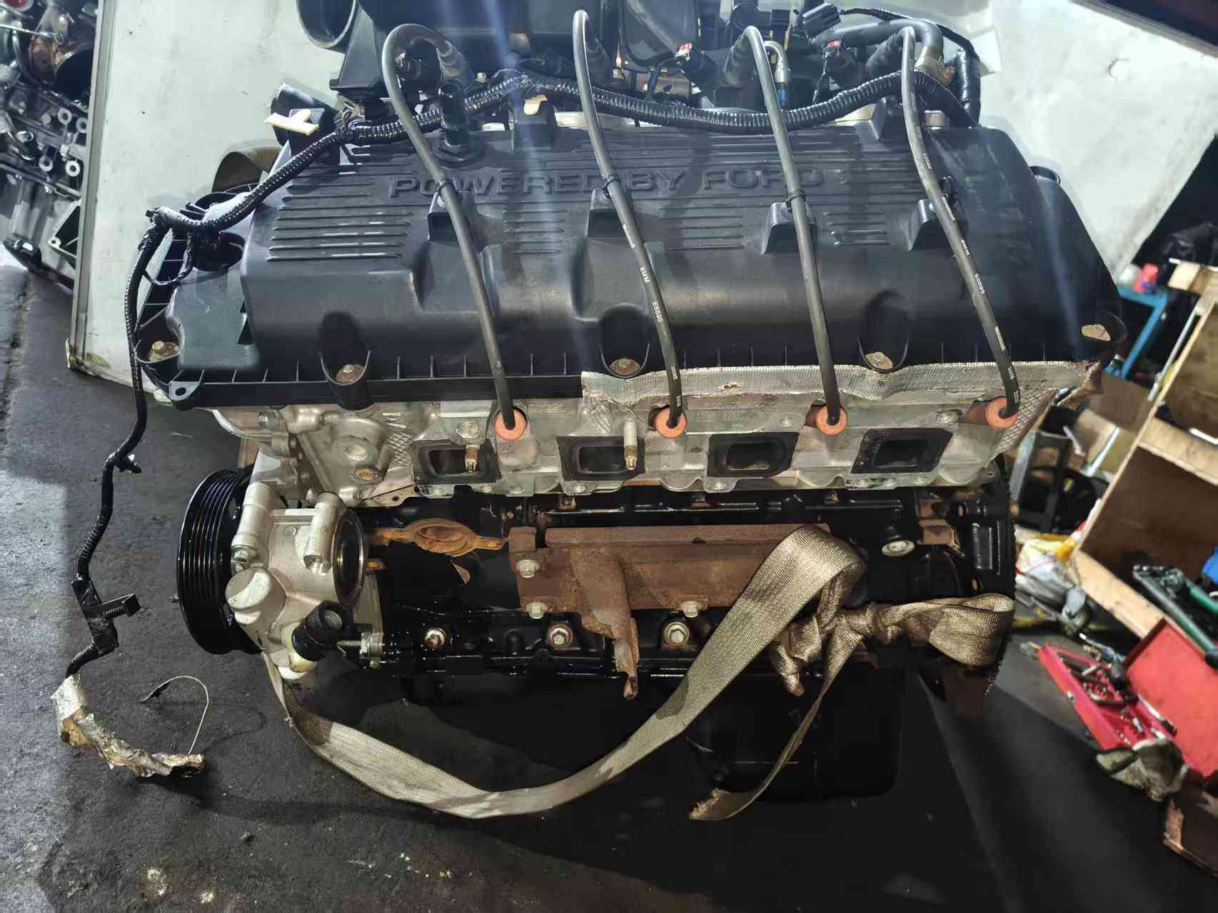 Ford 6.2 Duratec V8 engine valve cover side with exhaust ports and belt pulleys