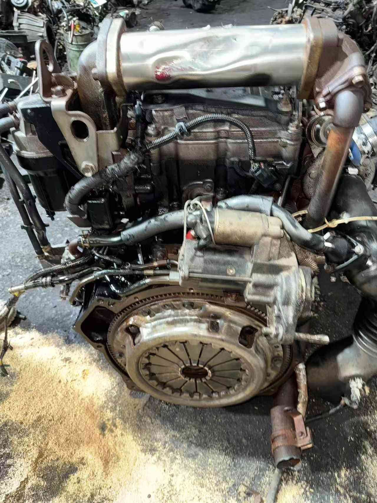 Isuzu 4HK1 engine front view with cooling fan, belt drive and water pump