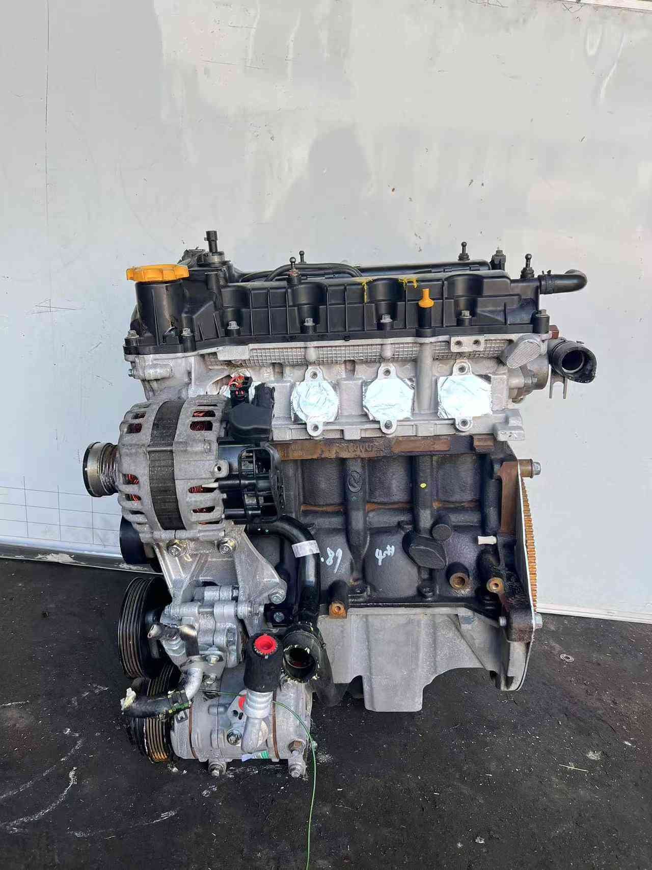 Under-side view of the 15S4U engine assembly, featuring the oil pan and structural ribbing.