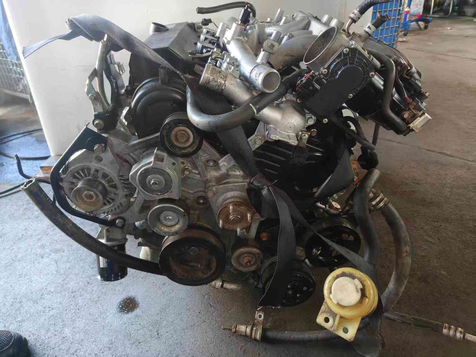 Fully assembled Mitsubishi 6B31 3.0 V6 engine block with belt system.