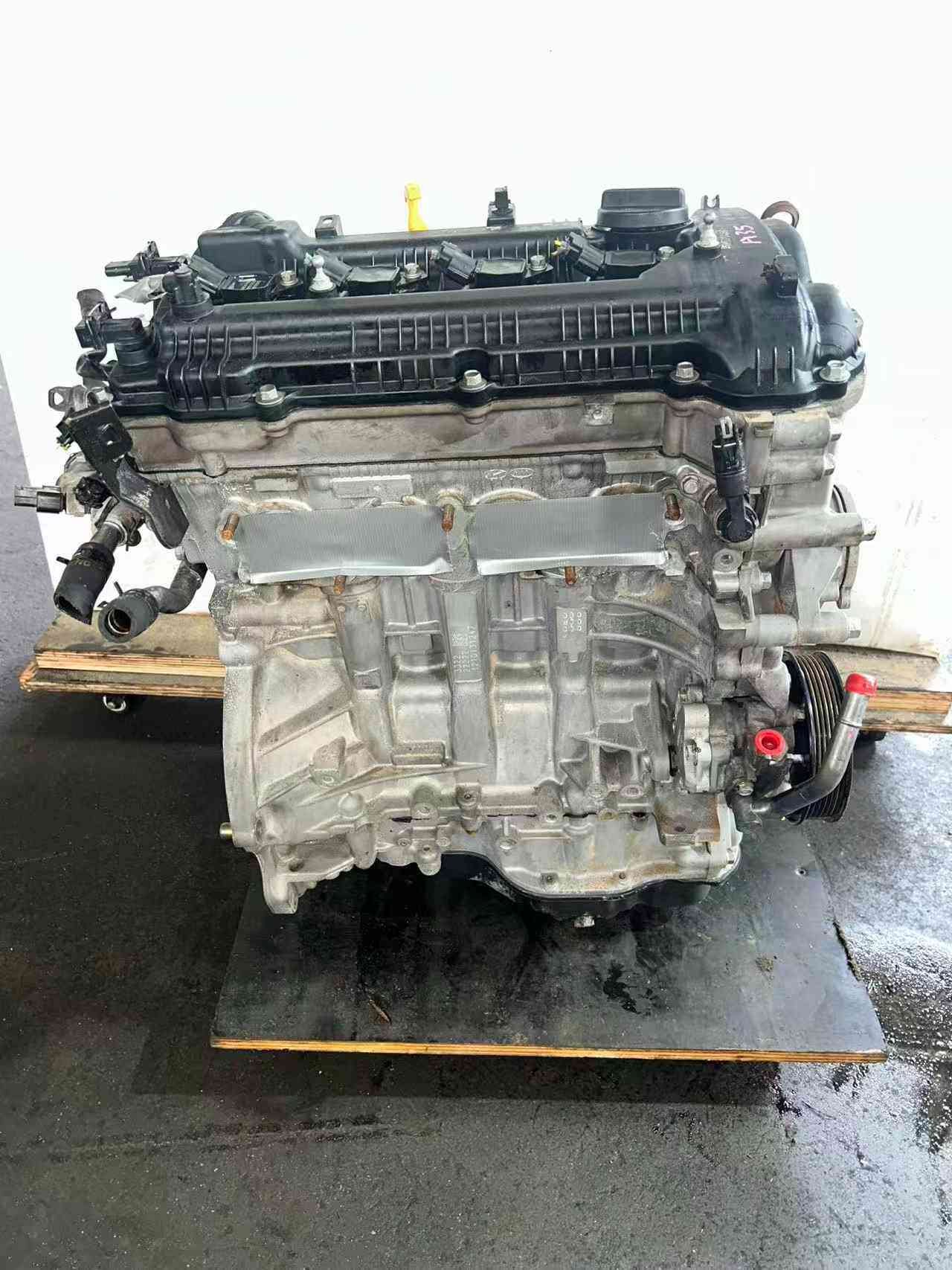 Genuine used Hyundai Elantra 1.8L Nu engine (G4NB) valve cover angle view for sale - cooling fins and handwritten marks