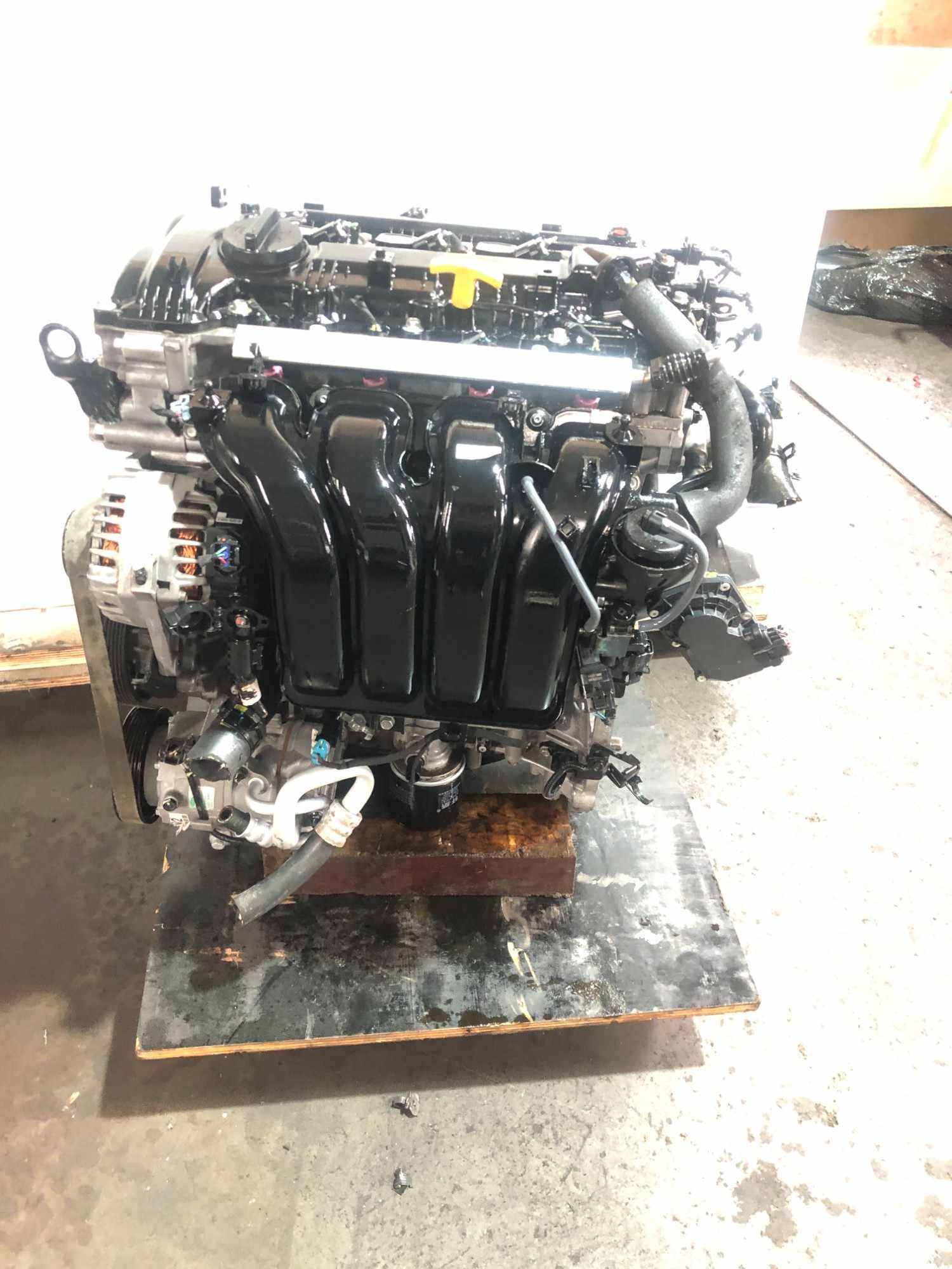Genuine used Hyundai Elantra 2.0L Nu engine (G4NA) alternator and oil filter close-up for sale - dipstick and clean accessories