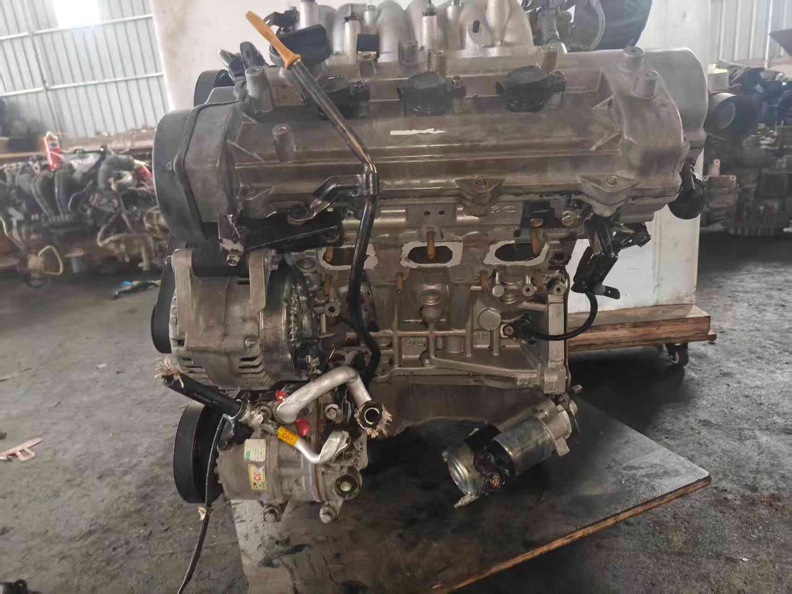 Genuine used Hyundai Grandeur 2.7L V6 engine (G6EA) complete assembly view for sale - stored on wooden platform