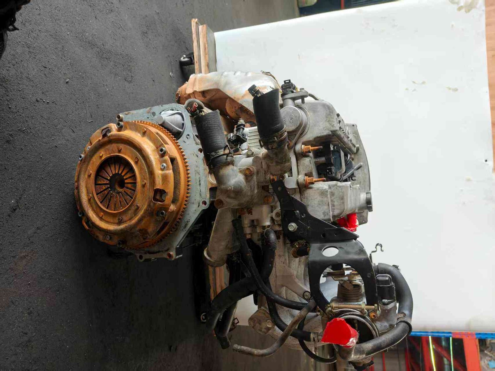 Genuine used Hyundai Starex 2.5L turbo diesel engine (D4BH) intake manifold and flywheel end view for sale - cast intake and used engine condition