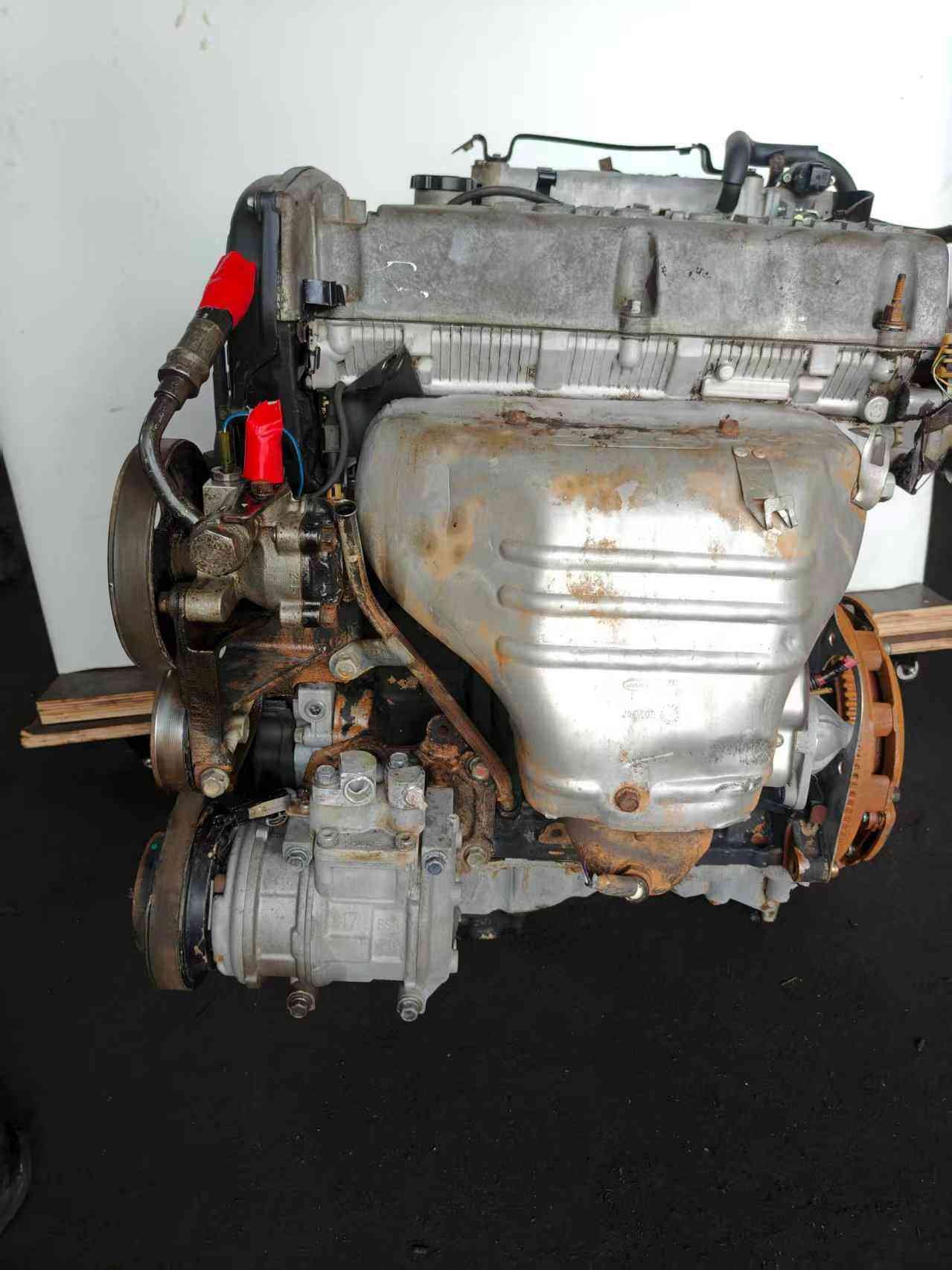 Genuine used Hyundai Sonata 2.0L Sirius II engine (G4JP) intake side view for sale - air compressor and wiring connectors