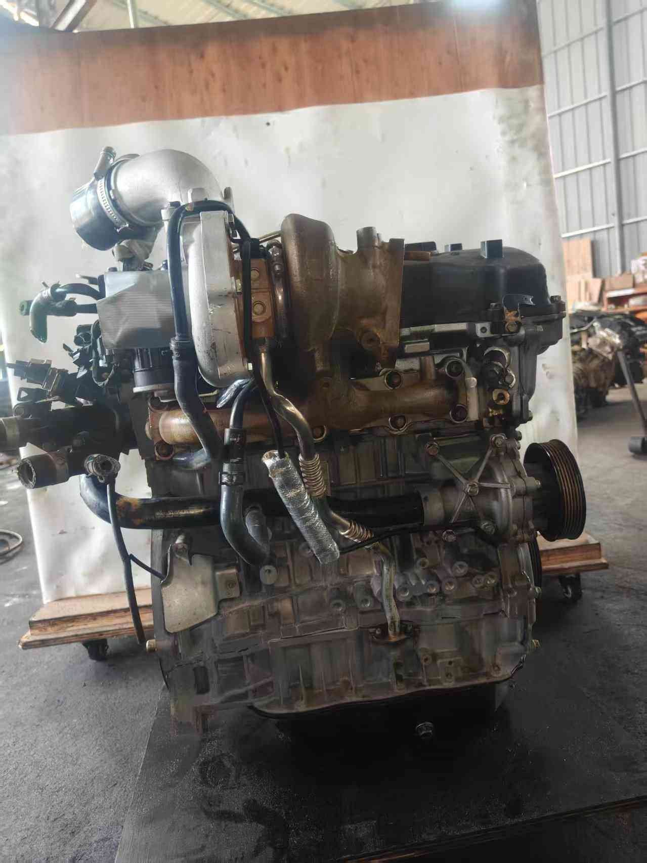 Genuine used Hyundai Sonata 2.0L turbo GDI engine (G4KH) turbocharger side view for sale - complete assembly on wheeled stand