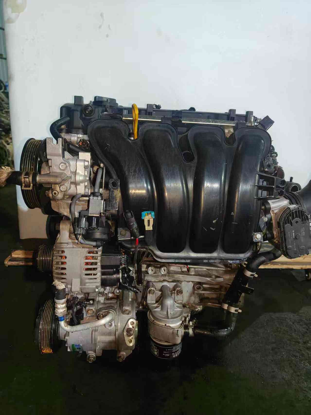 Genuine used Hyundai Sonata 2.4L Theta II MPI engine (G4KE) intake manifold side view for sale - black intake manifold, dipstick and alternator