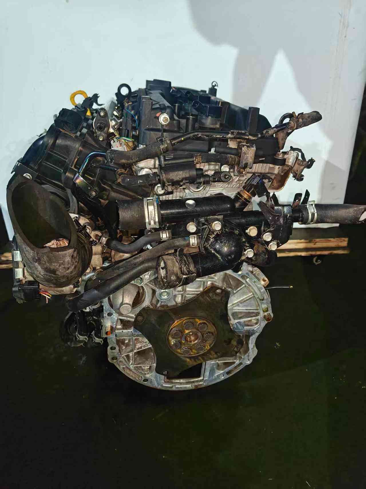 Genuine used Hyundai Sonata 2.4L Theta II engine (G4KE) complete assembly view for sale - lifting eye, intake pipe and worn components