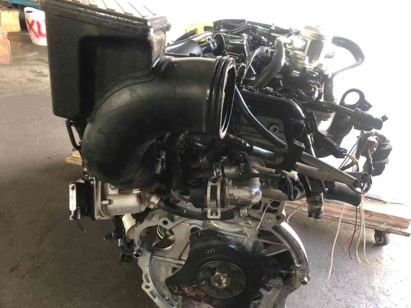 Genuine used Hyundai Tucson 2.0L Nu GDI engine (G4NC) flywheel end view for sale - assembly on wheeled stand
