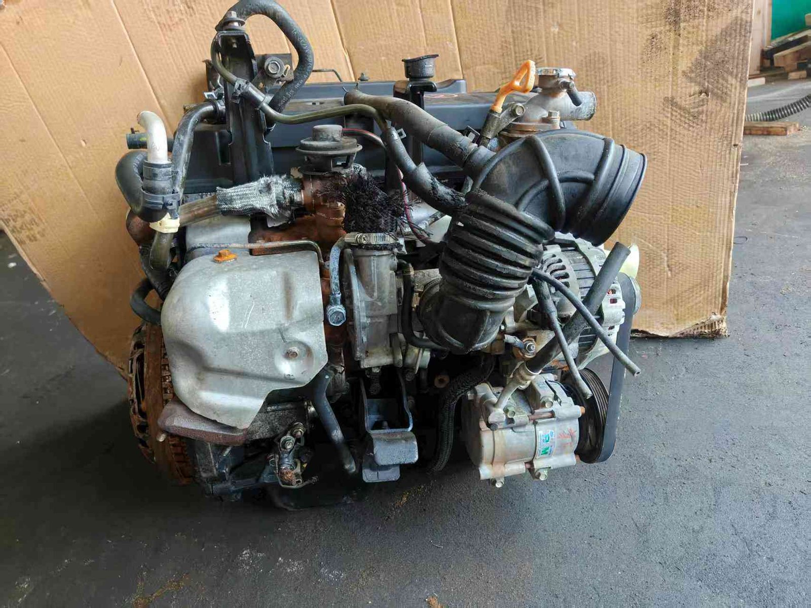 Genuine used Kia Carnival 2.9L turbo diesel engine (J3) accessory drive side view for sale - belts, alternator and AC compressor