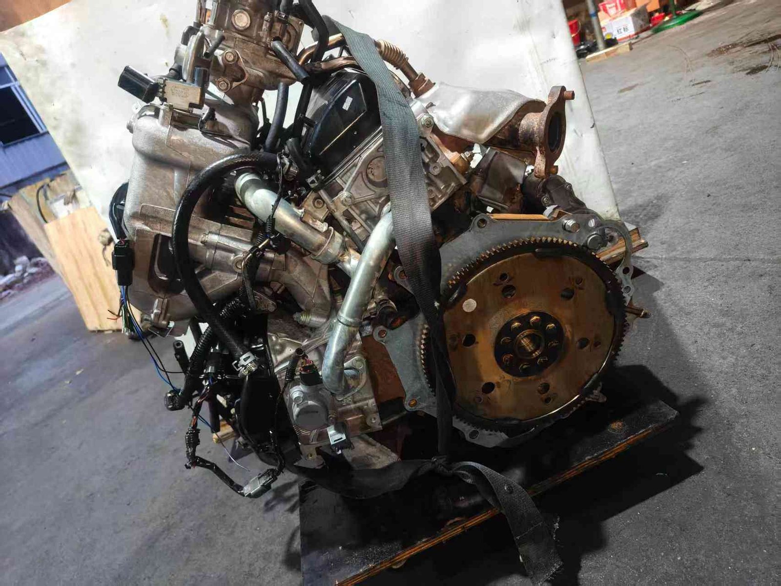 Side view of the massive Mitsubishi 6G75 V6 engine block assembly.