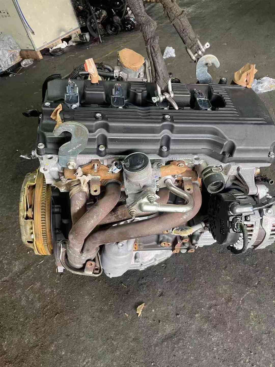 1. Close up of Toyota 1TR engine valve cover and intake manifold