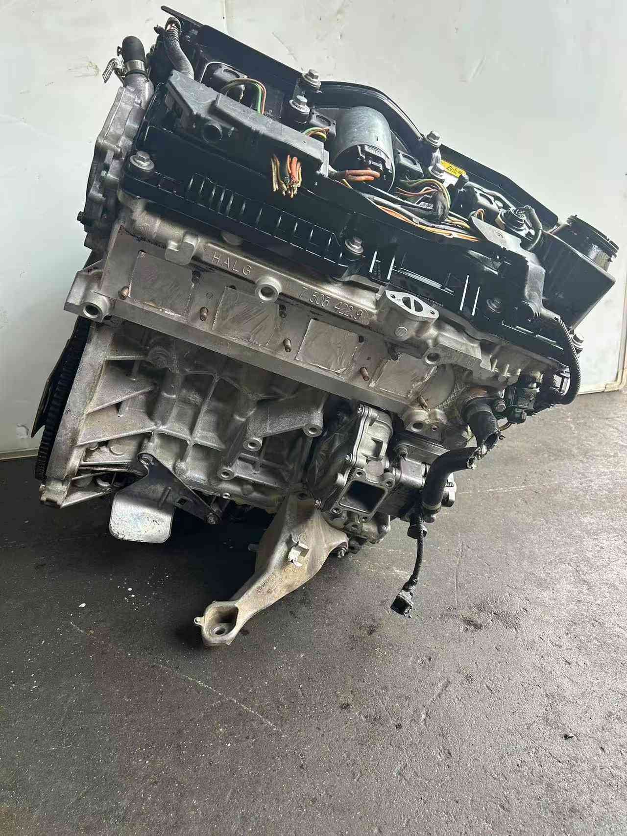 BMW N42 complete used engine assembly shown from the side with wiring and mounting components