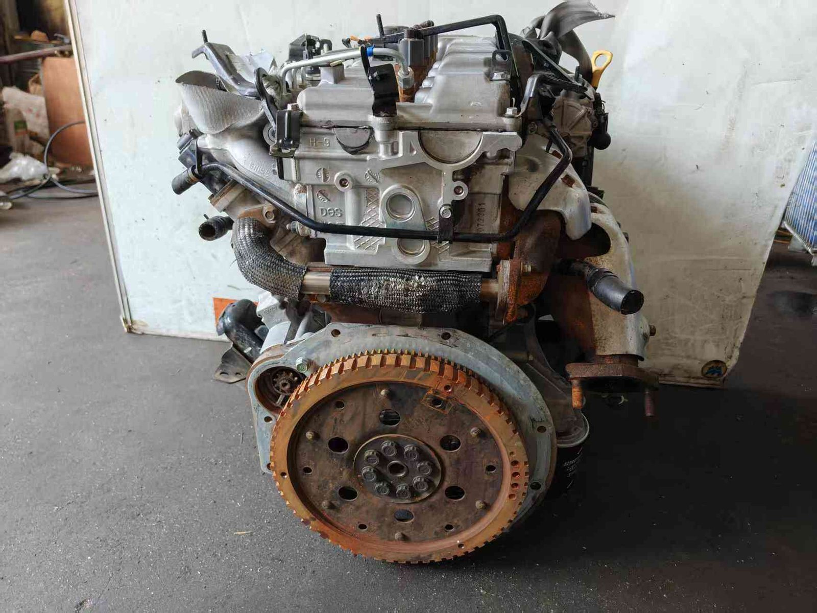 Hyundai Kia D4CB used engine rear view showing flywheel and turbocharger assembly
