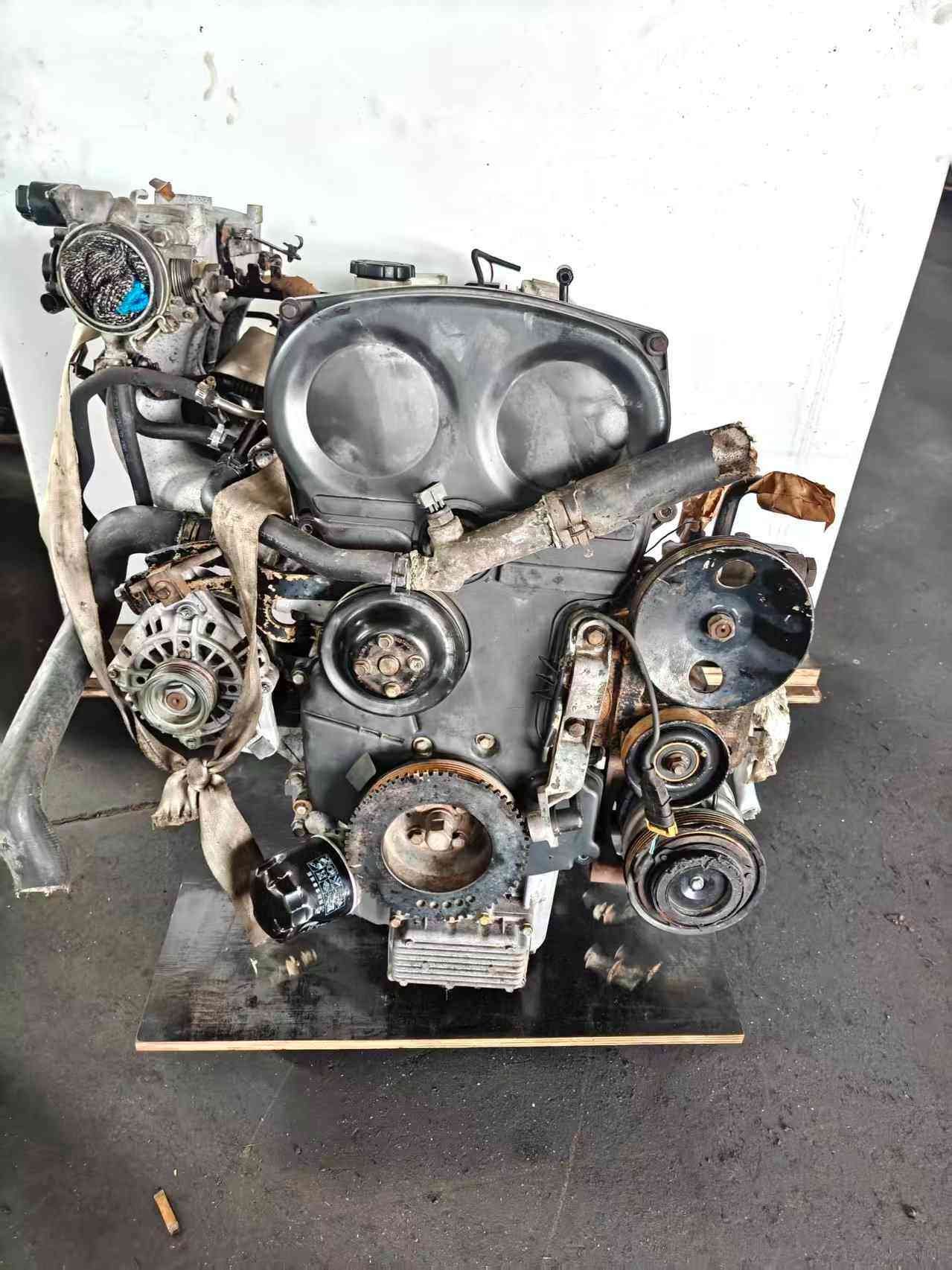 Hyundai Kia G4JS used engine front view with timing cover, pulleys and alternator
