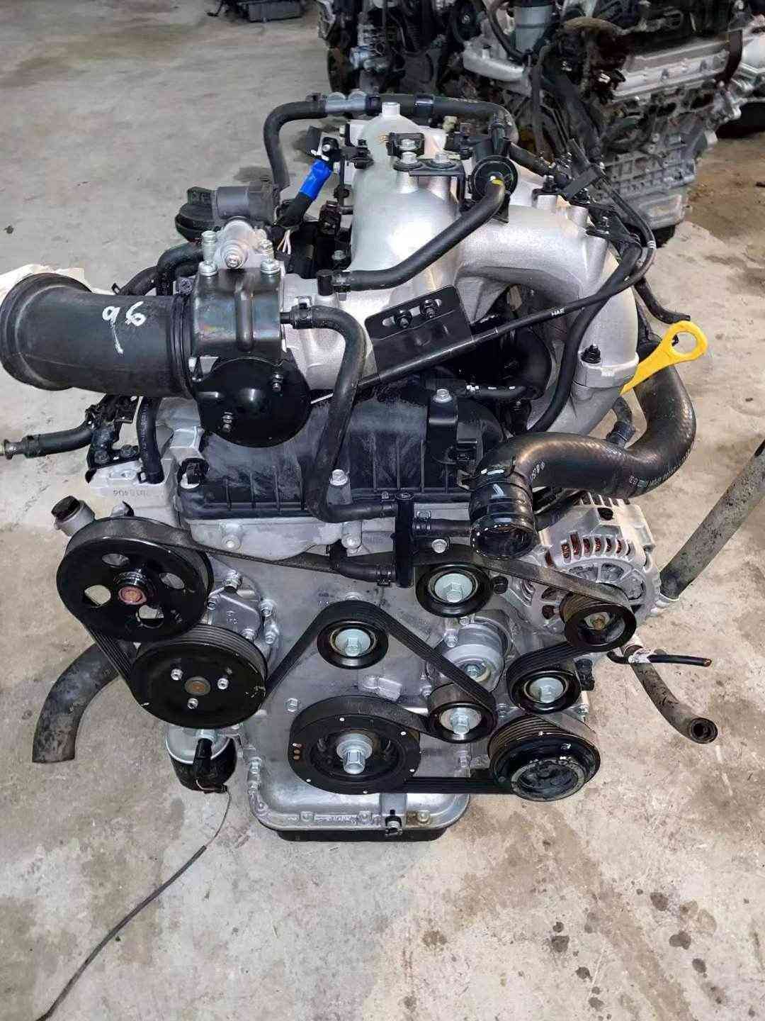 Hyundai Kia G4KG used engine front view with serpentine belt, pulleys and alternator