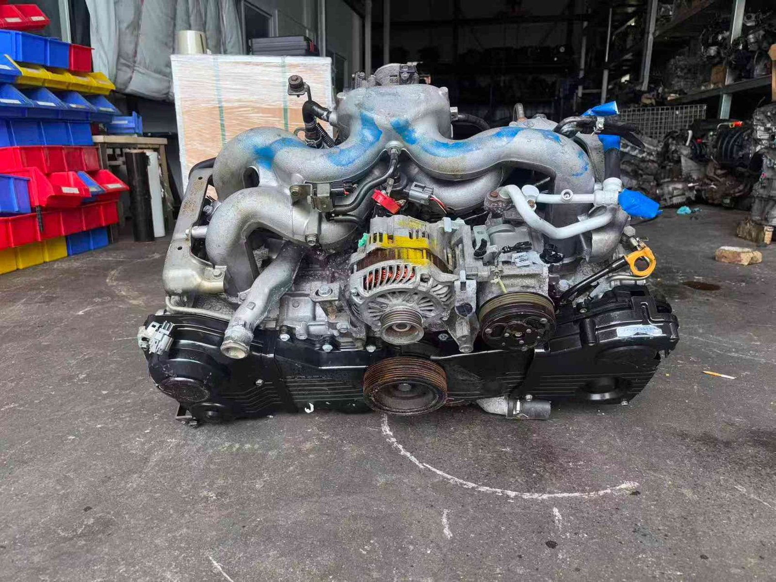 Subaru EJ20 engine assembly front accessory view with alternator, intake manifold and crankshaft pulley