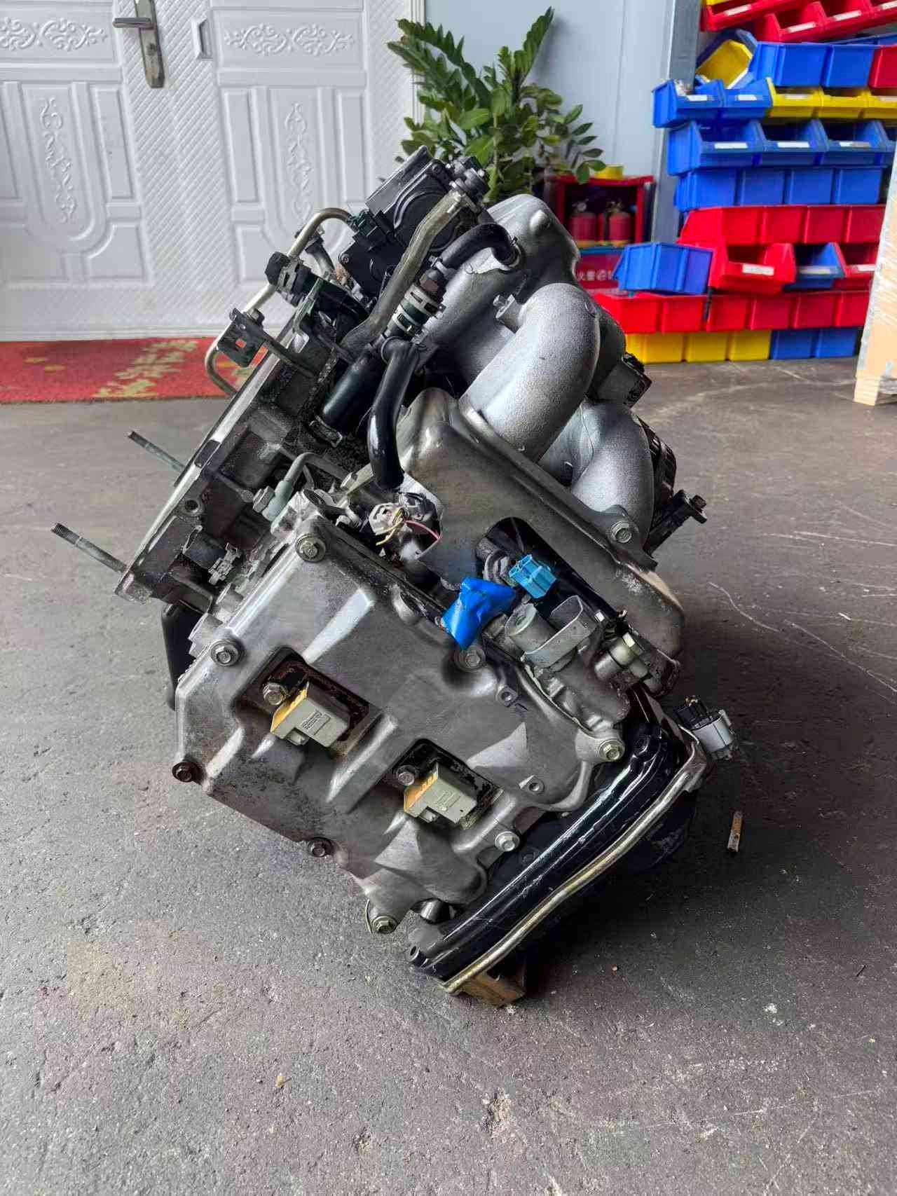 Subaru EJ20 engine assembly side view with intake manifold, wiring connectors and valve cover