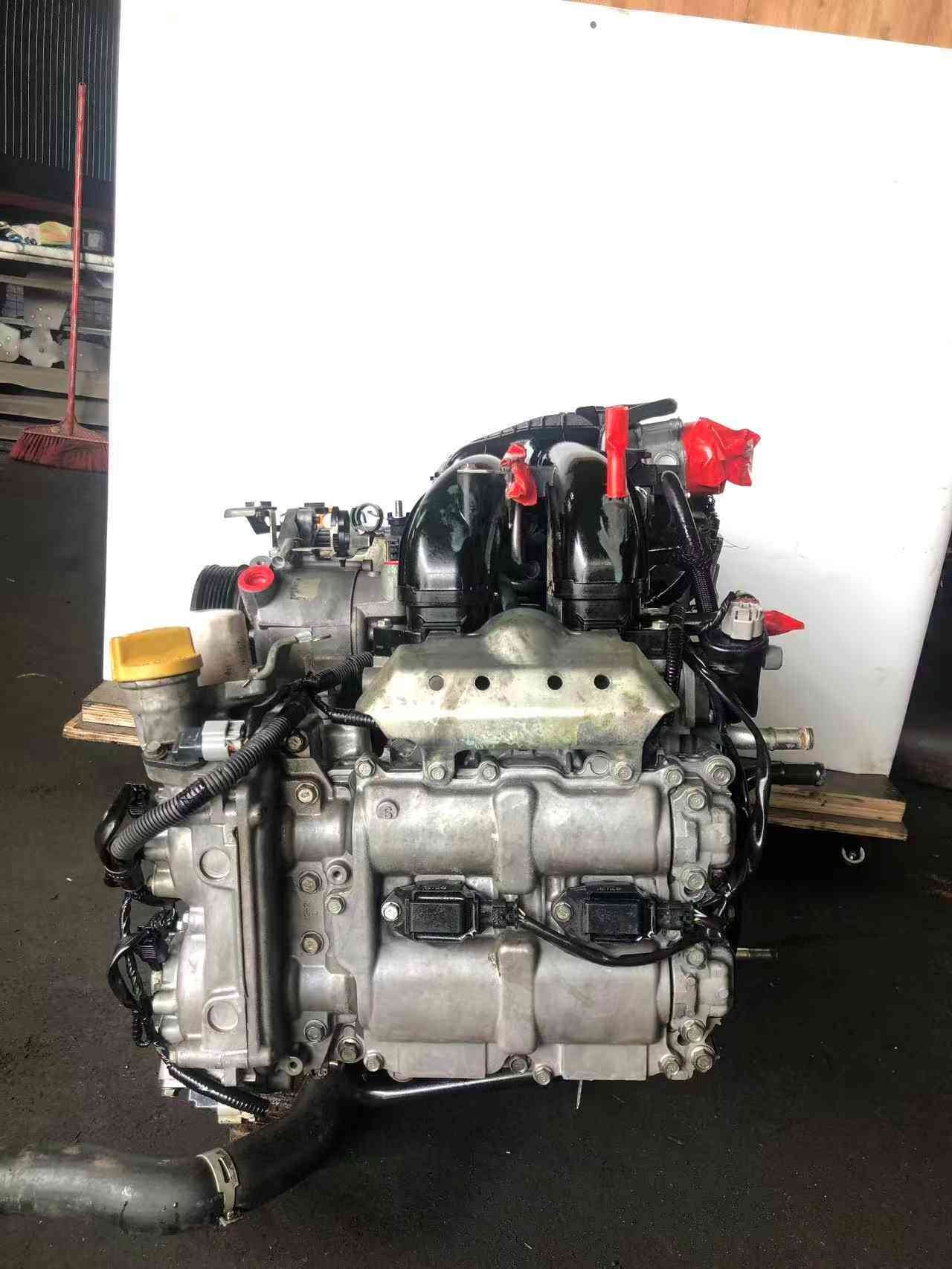 Subaru FB20 engine assembly side view showing cylinder head, intake manifold and ignition coil connectors