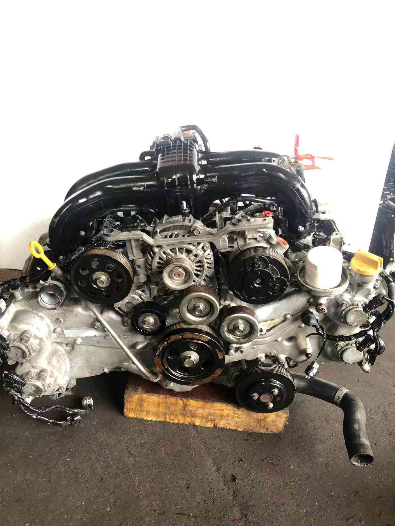 Subaru FB20 engine assembly front accessory view with alternator, pulleys, oil filter and intake manifold