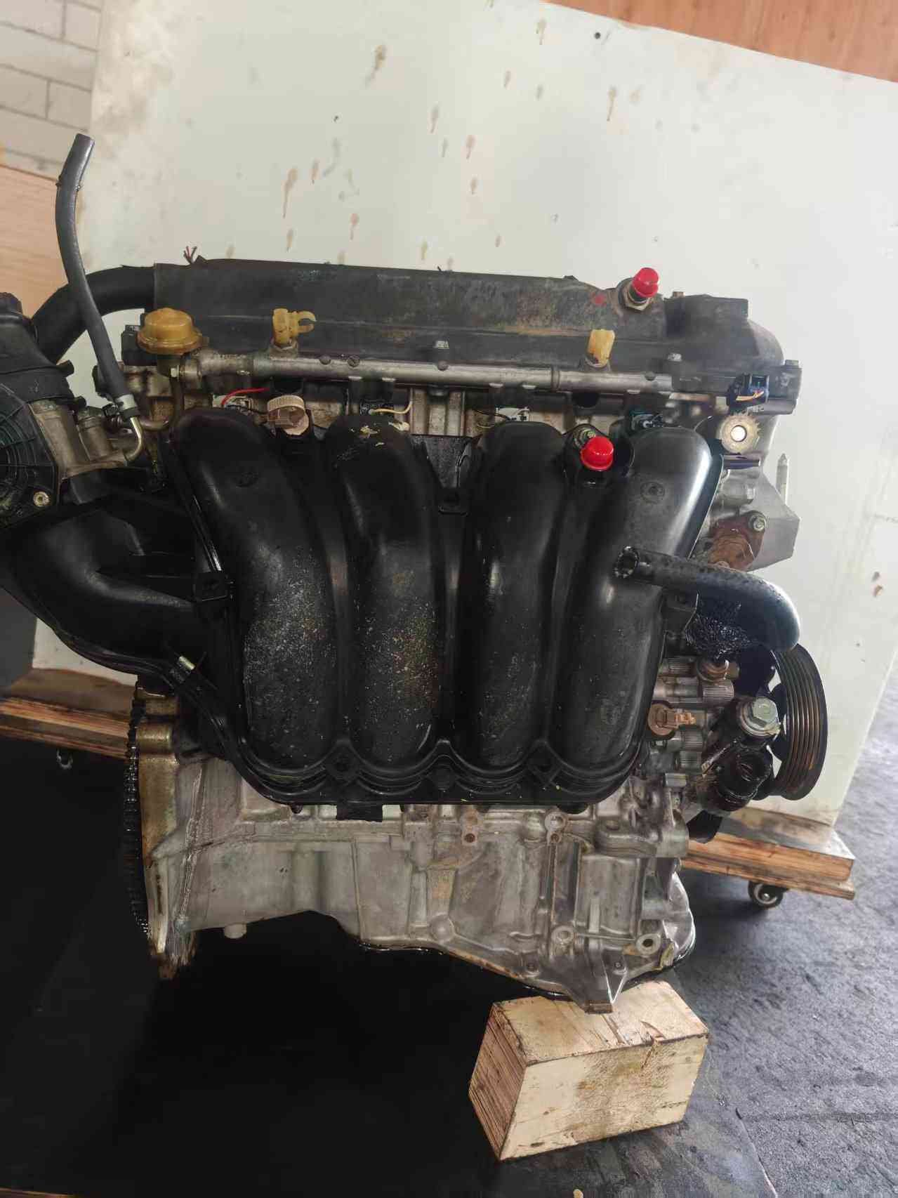 Toyota 1AZ engine intake side with black manifold and transmission housing