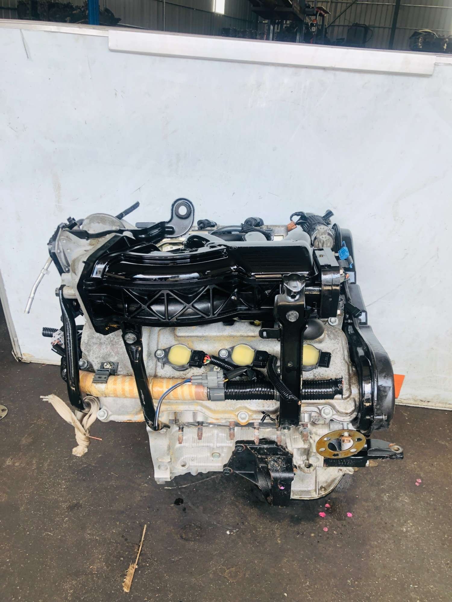 Toyota 3MZ-FE engine side view with black intake plenum and ignition coils