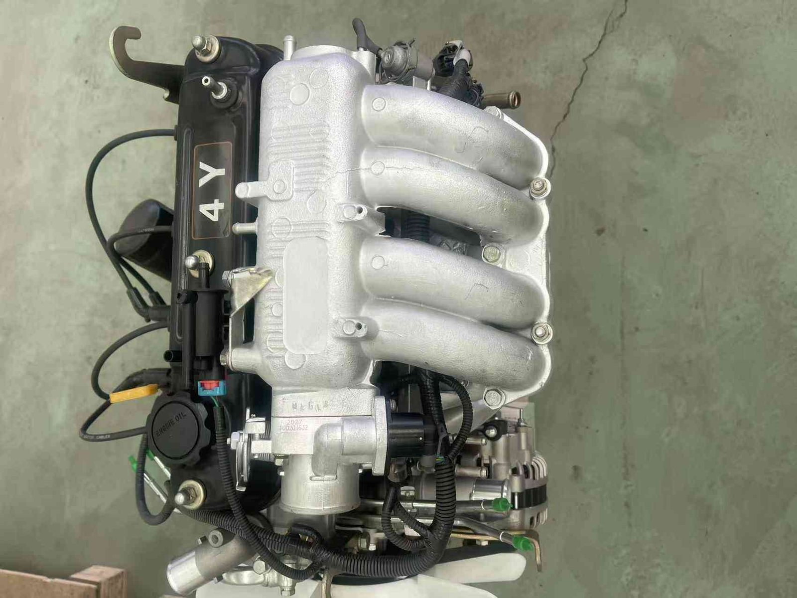 Top view of Toyota 4Y engine showing intake runners and ignition wiring