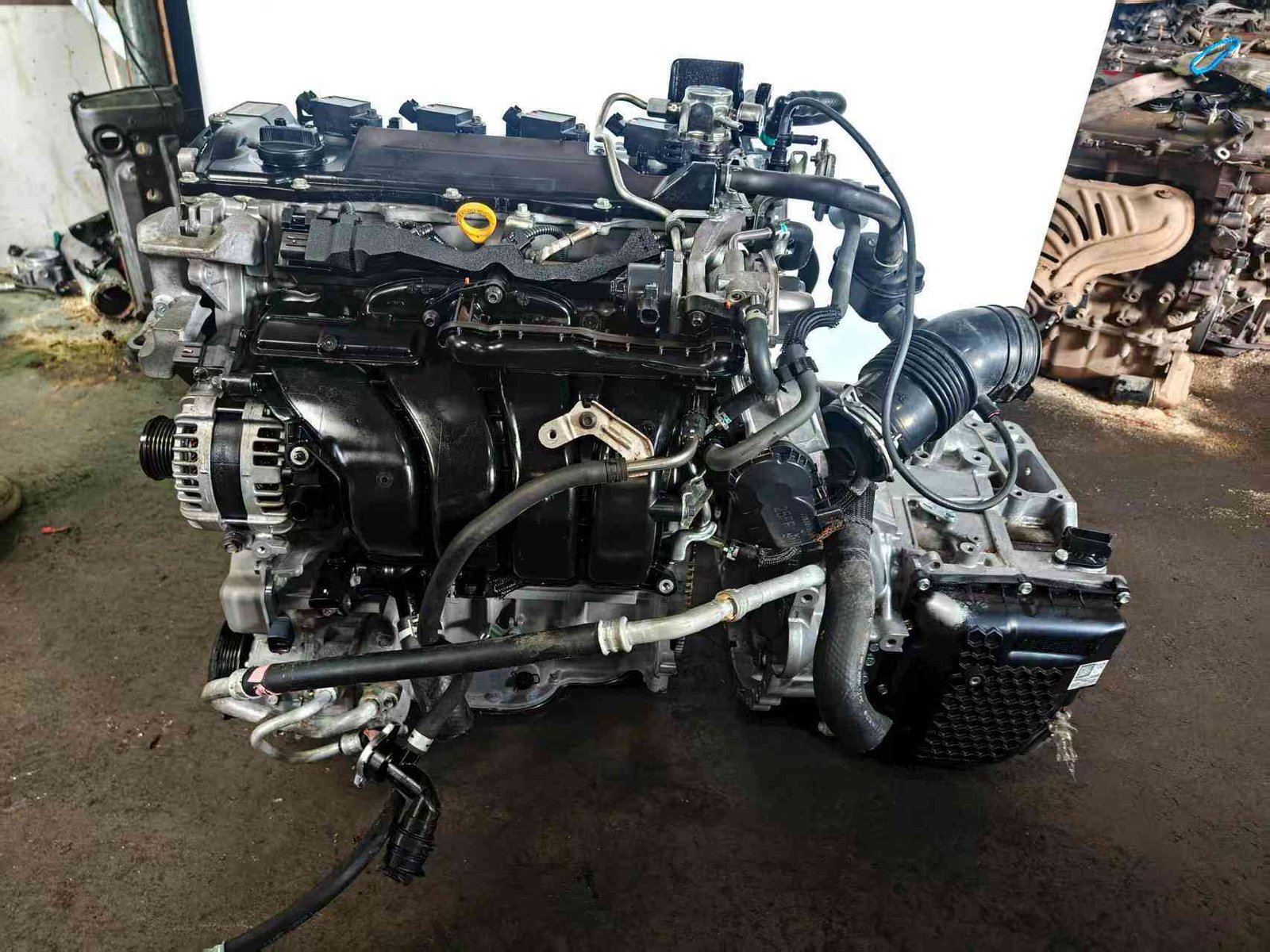 Toyota A25A engine and transmission assembly with intake manifold and alternator