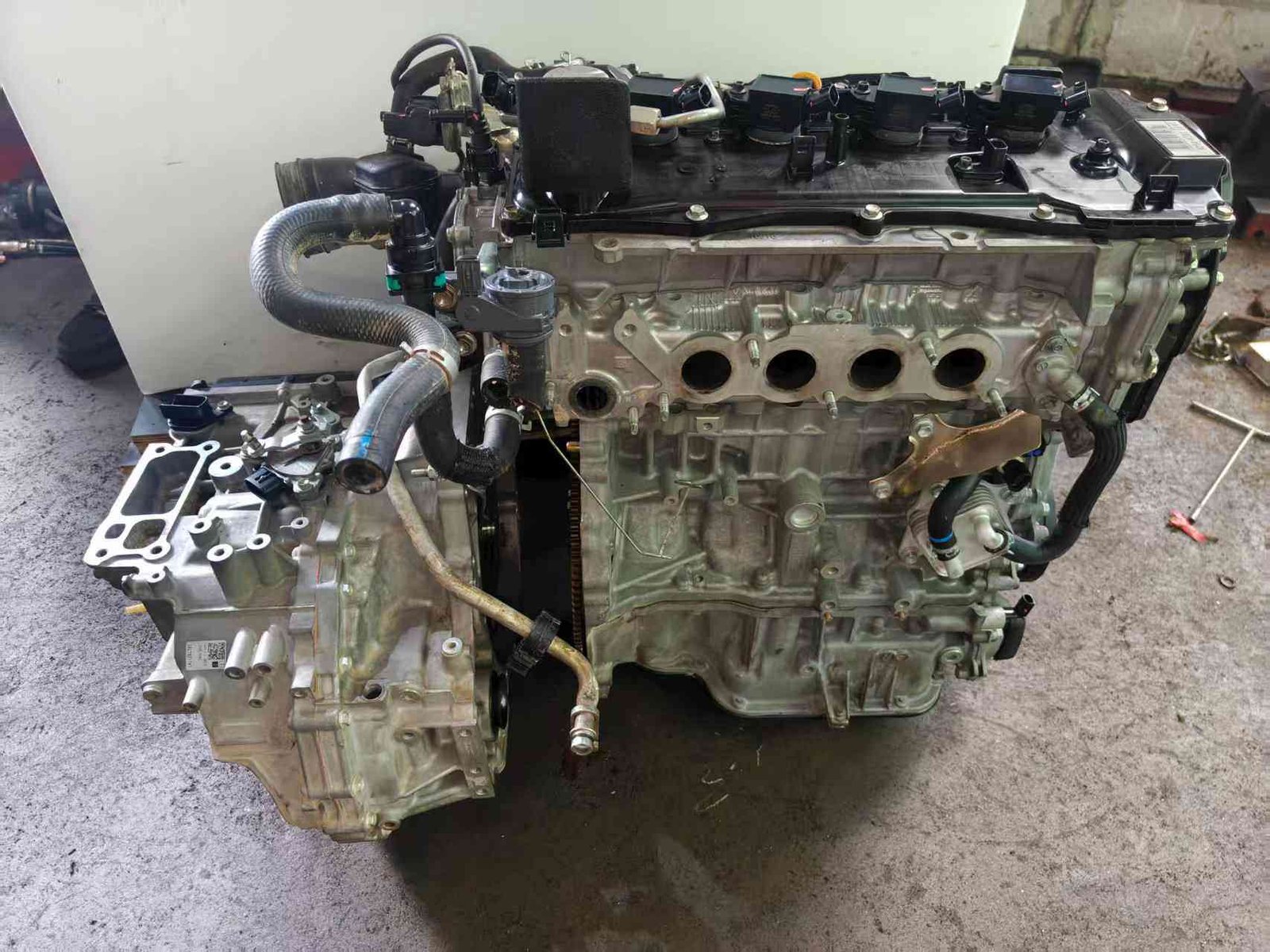 Toyota A25A engine exhaust side with open cylinder head ports and transmission