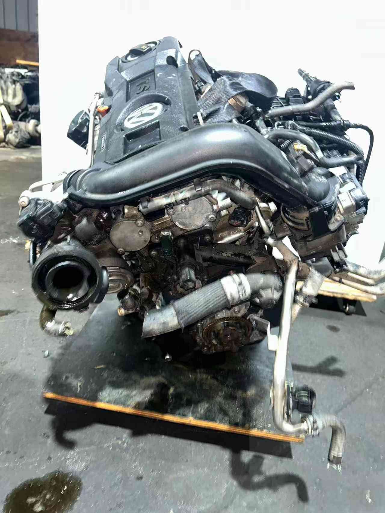 Volkswagen EA111 CFB engine intake-side view showing the intake opening, hoses, and wiring harness.