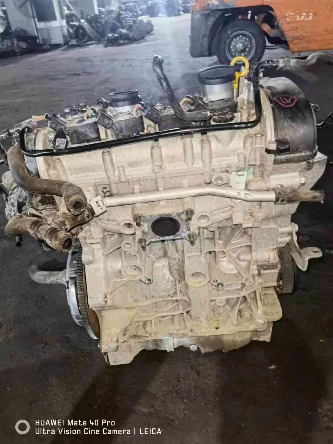 Volkswagen EA211 CKA engine block-side view with side coolant pipe, cylinder block casting, and flywheel edge.