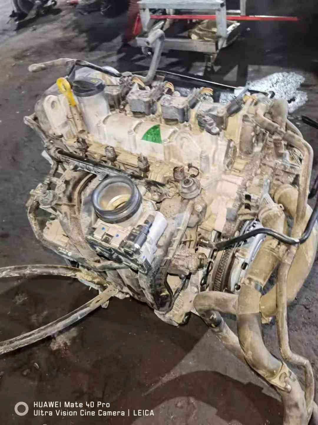 Flywheel-side view of a Volkswagen EA211 CKA engine with intake opening, clutch housing, and upper ignition coils.