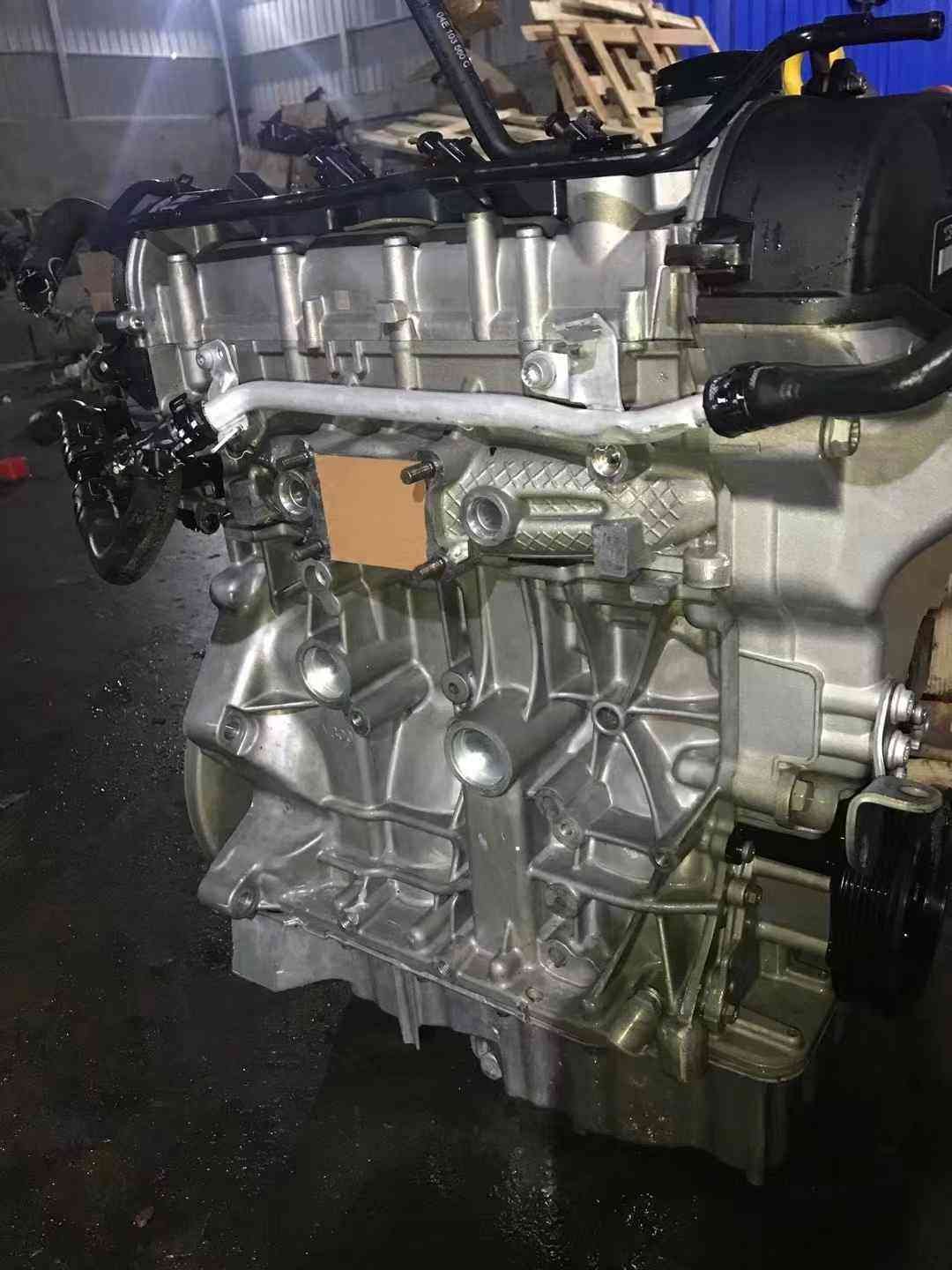 Side view of a Volkswagen EA211 CSR engine showing the aluminum cylinder block, coolant pipe, and mounting points.