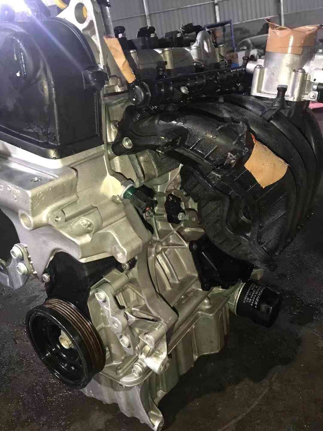 Volkswagen EA211 CSR engine showing black plastic intake manifold, aluminum block, oil filter, and front pulley.