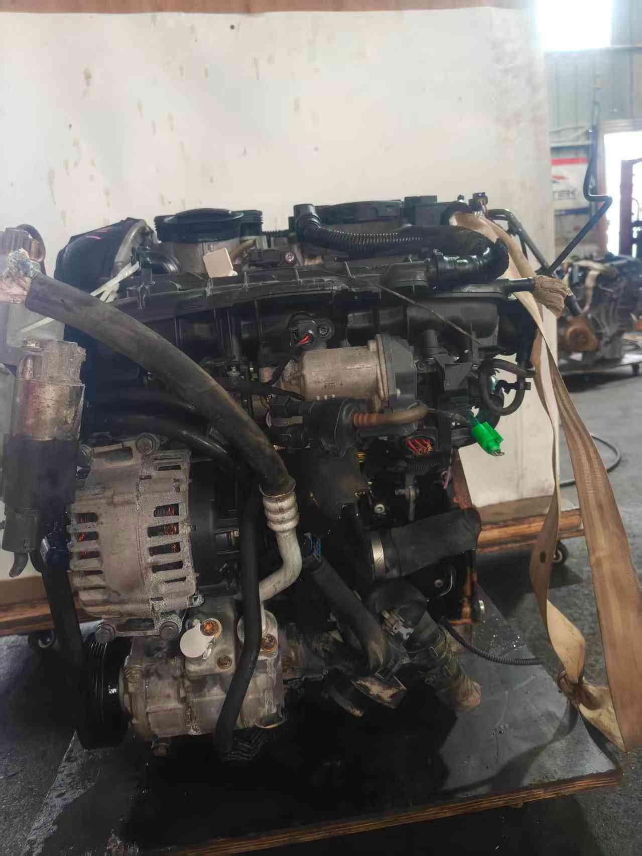 Accessory-side view of a Volkswagen EA888 Gen 2 CCZ engine showing alternator, intake manifold, hoses, and wiring.