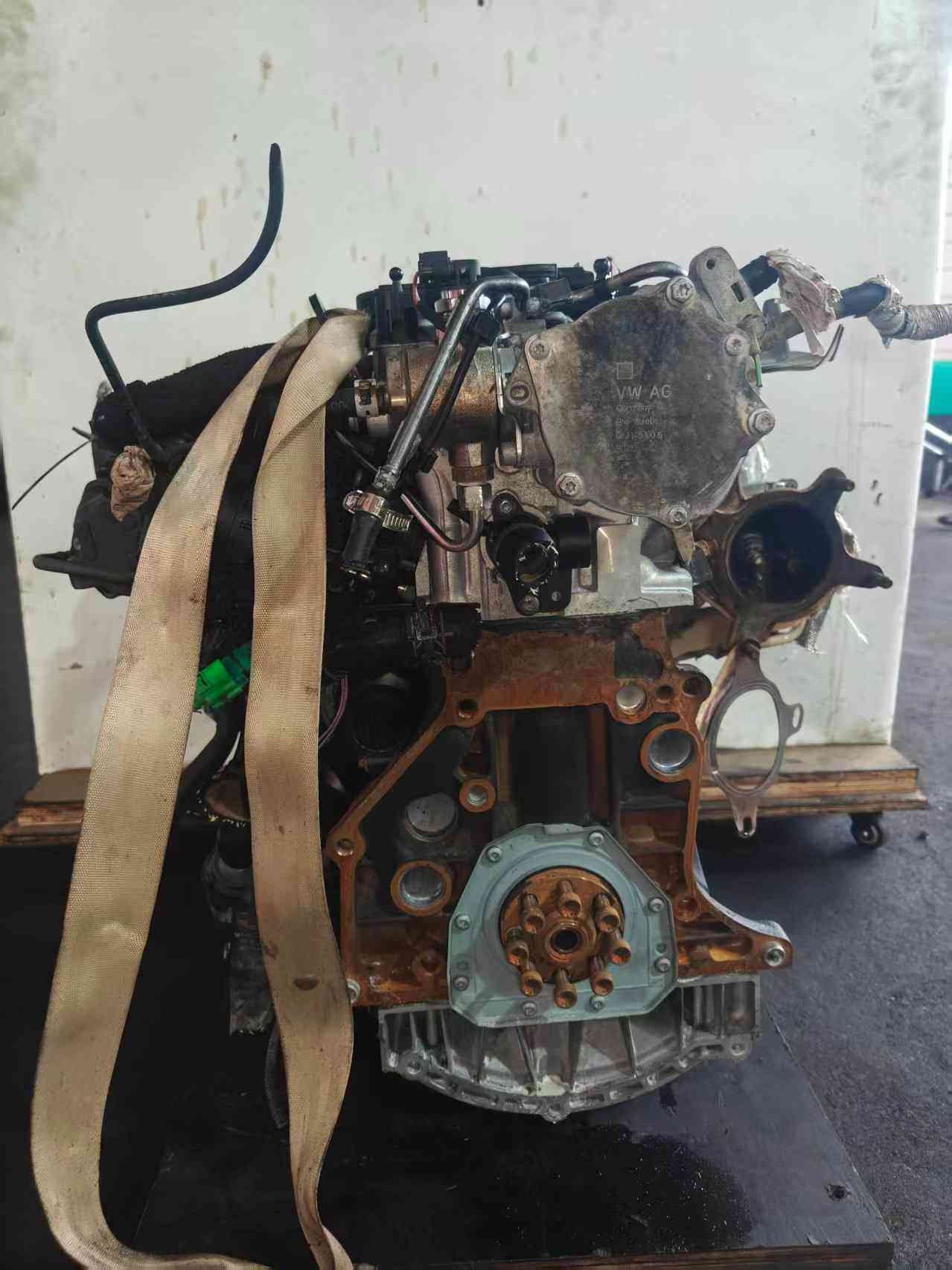 Volkswagen EA888 Gen 2 CCZ engine flywheel-side view with rear crankshaft flange, vacuum pump housing, and mounting surface.