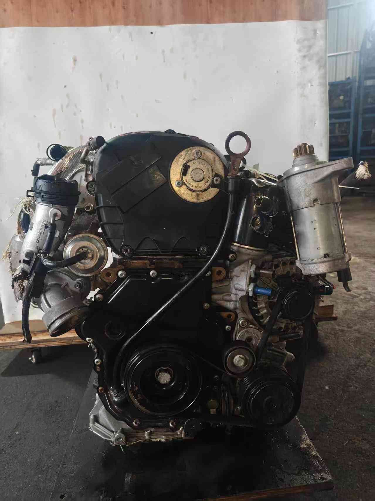 Volkswagen EA888 Gen 2 CCZ engine timing-cover side with crank pulley, starter motor, and turbocharger plumbing.