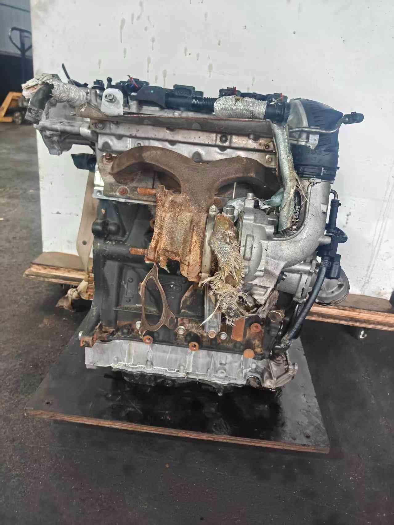 Volkswagen EA888 Gen 2 CCZ engine turbocharger-side view showing exhaust manifold, turbo assembly, and heat-wrapped lines.
