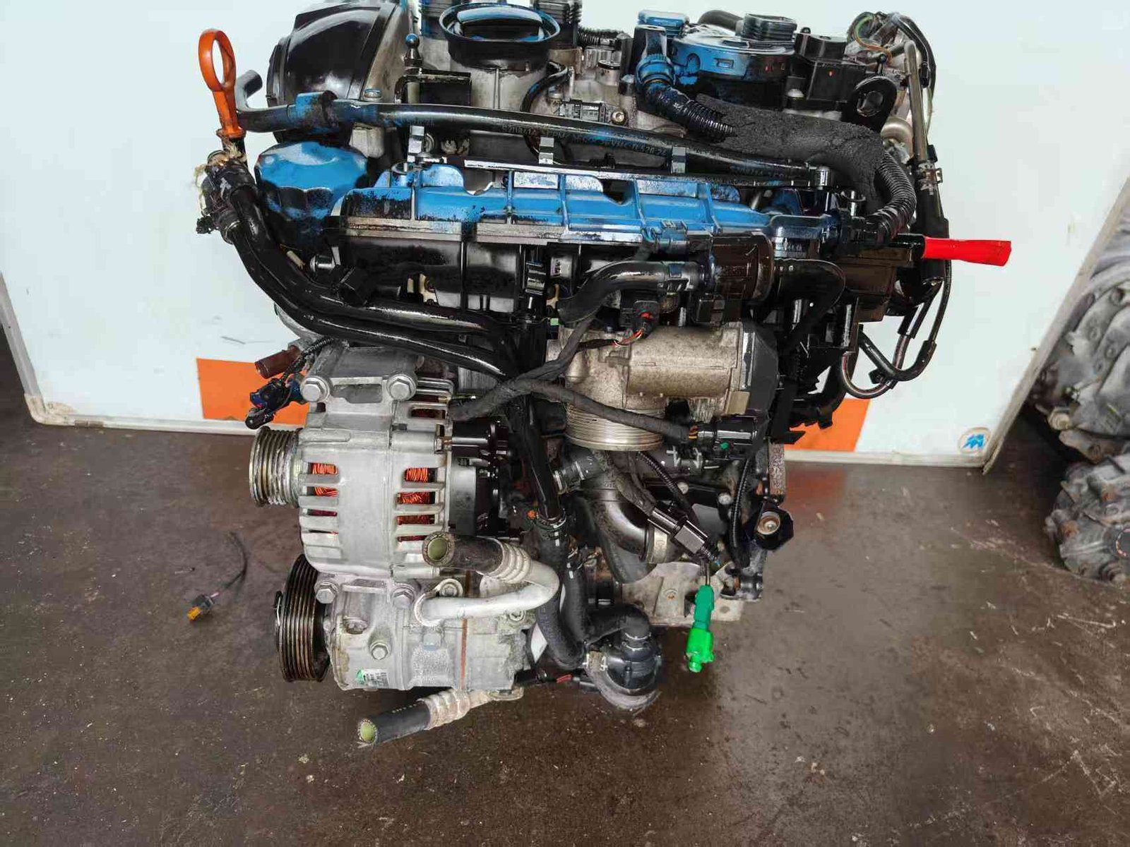 Volkswagen EA888 Gen 2 CDA engine front-side view showing alternator, air-conditioning compressor, intake manifold, and hoses.