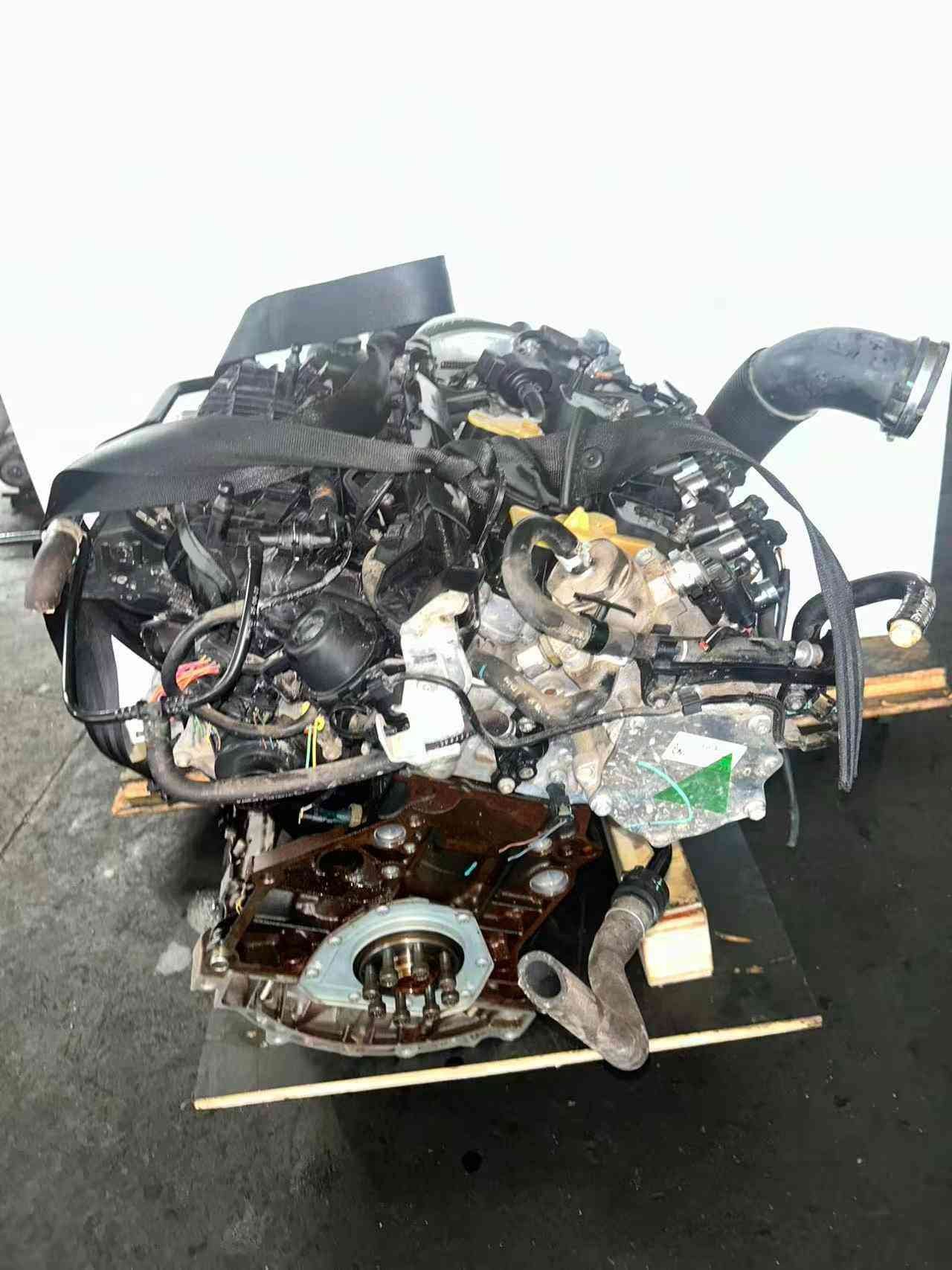 Volkswagen EA888 Gen 3 CJE engine flywheel-side view with rear crankshaft flange, coolant lines, and intake system components.